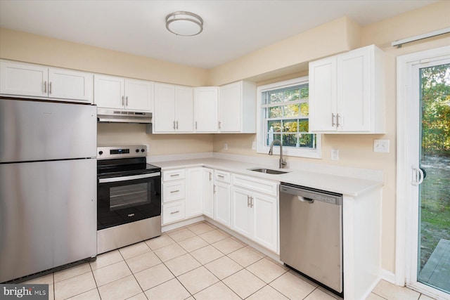 kitchen with white cabinetry, light tile patterned floors, stainless steel appliances, and sink