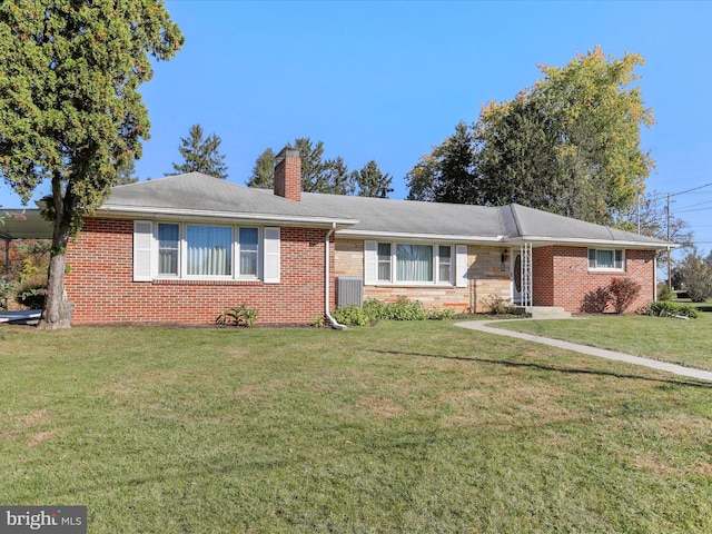 ranch-style home featuring central AC and a front yard