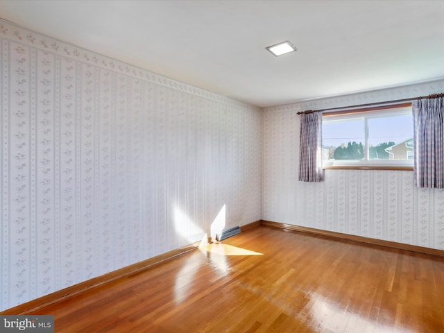 spare room with hardwood / wood-style floors