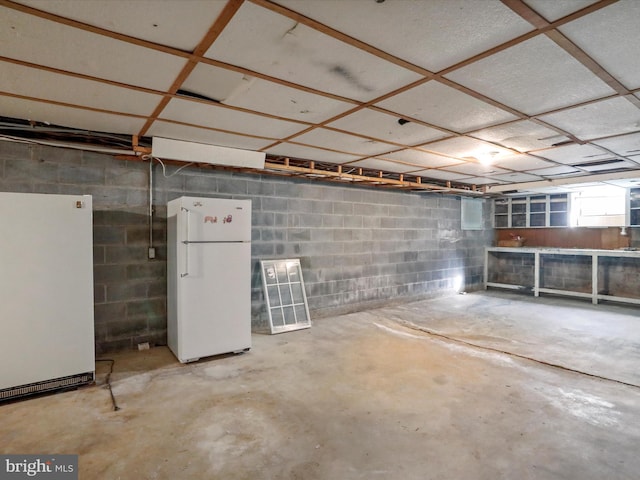 basement with white refrigerator