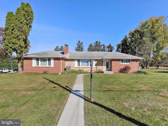 ranch-style home with cooling unit and a front lawn