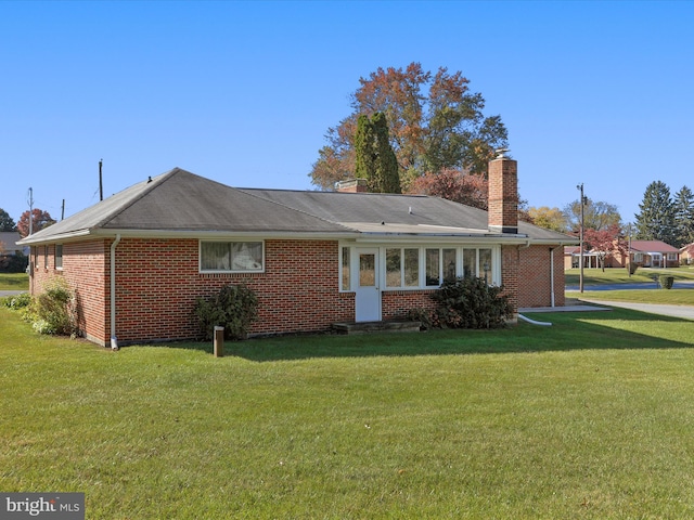 back of house featuring a lawn