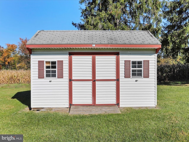 view of outbuilding with a yard