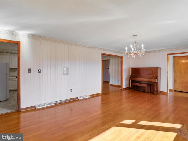 interior space featuring a notable chandelier and hardwood / wood-style floors