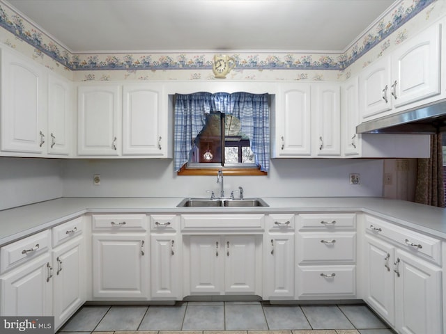 kitchen featuring sink, white cabinets, and light tile patterned flooring