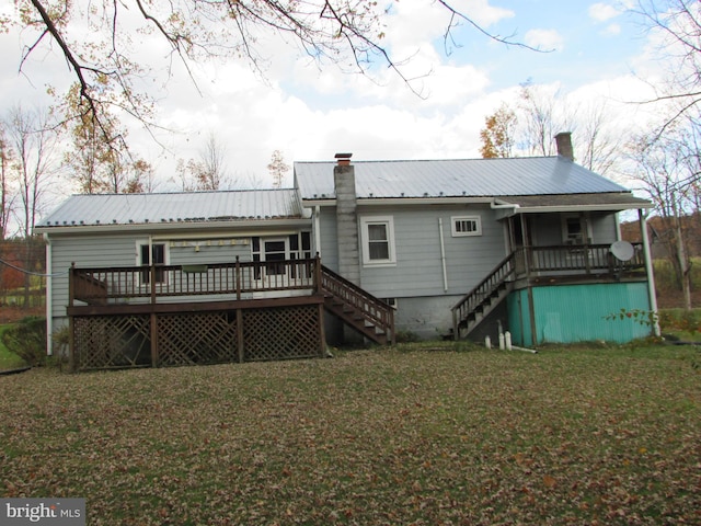 rear view of property with a yard and a deck