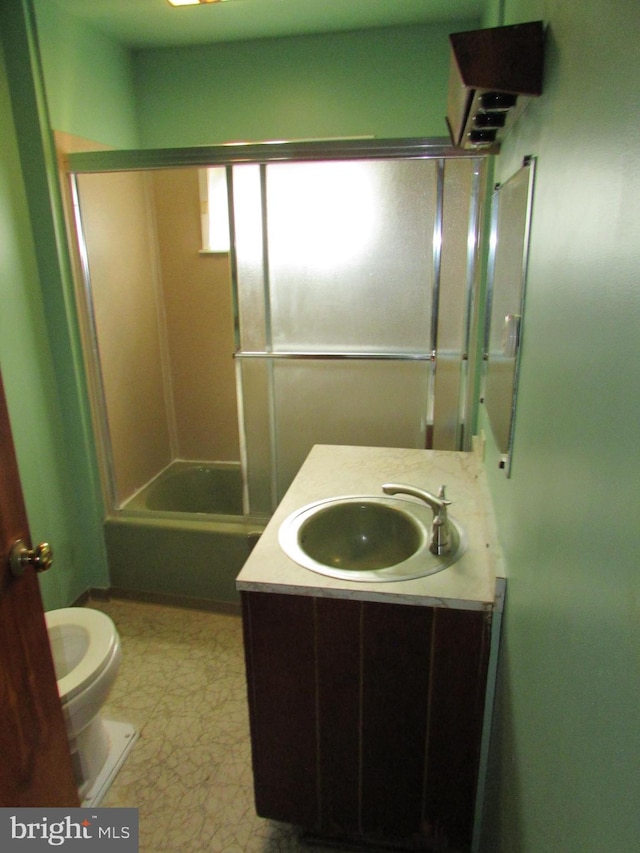 full bathroom featuring vanity, bathtub / shower combination, and toilet