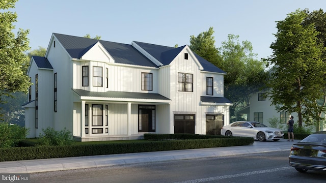 modern farmhouse featuring covered porch, board and batten siding, and metal roof