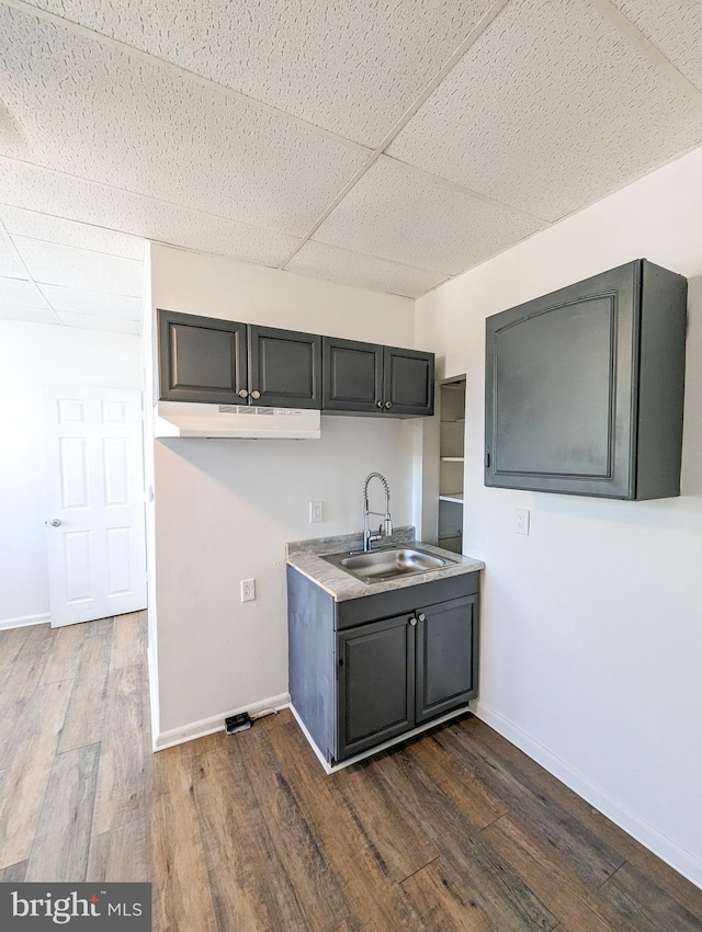 5200 Ballman, Brooklyn, MD 21225 - kitchen with dark wood-style floors, baseboards, a drop ceiling, and a sink