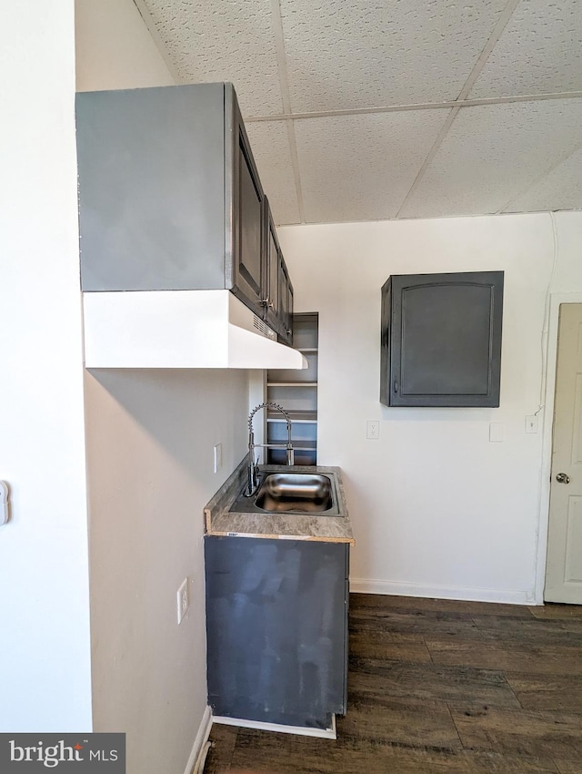 5200 Ballman, Brooklyn, MD 21225 - kitchen with a paneled ceiling, baseboards, dark wood-style floors, and a sink