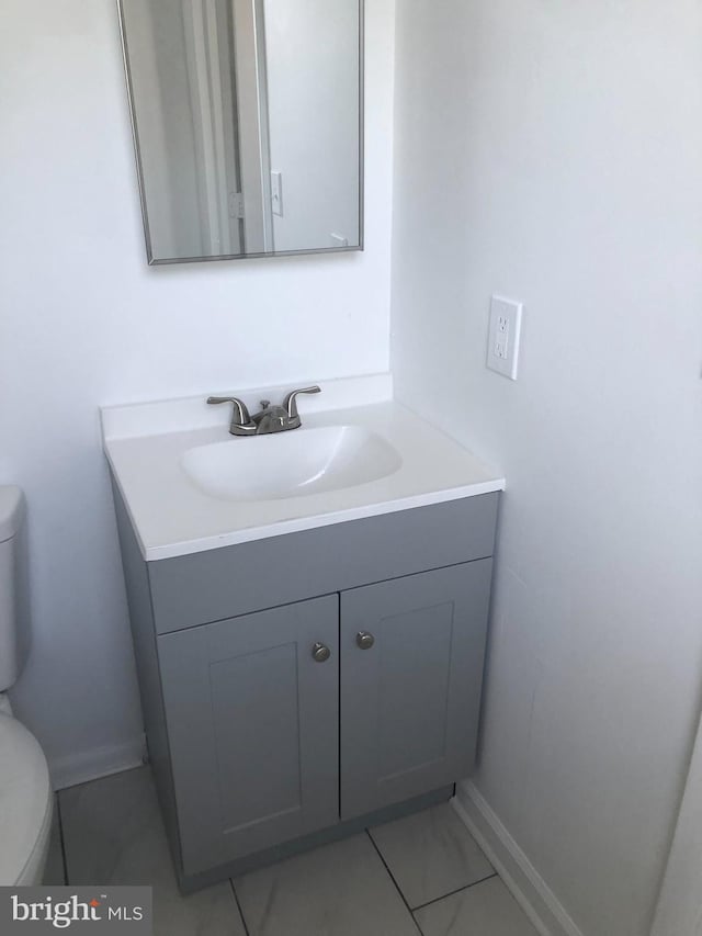 5200 Ballman, Brooklyn, MD 21225 - half bathroom with toilet, marble finish floor, vanity, and baseboards