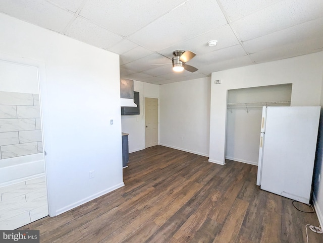 5200 Ballman, Brooklyn, MD 21225 - unfurnished bedroom with dark wood finished floors, a drop ceiling, freestanding refrigerator, and a closet