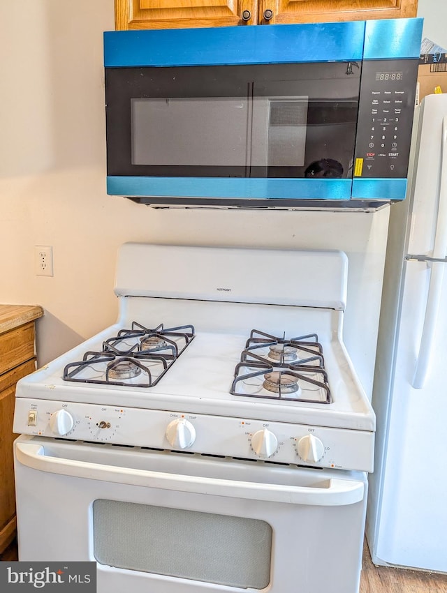 5200 Ballman, Brooklyn, MD 21225 - details featuring brown cabinets, white appliances, and light countertops