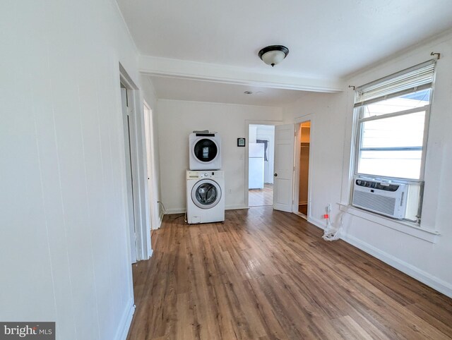 5200 Ballman, Brooklyn, MD 21225 - interior space featuring stacked washer / drying machine, baseboards, wood finished floors, cooling unit, and laundry area