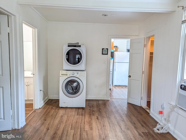 5200 Ballman, Brooklyn, MD 21225 - washroom featuring stacked washer and dryer, wood finished floors, crown molding, and laundry area
