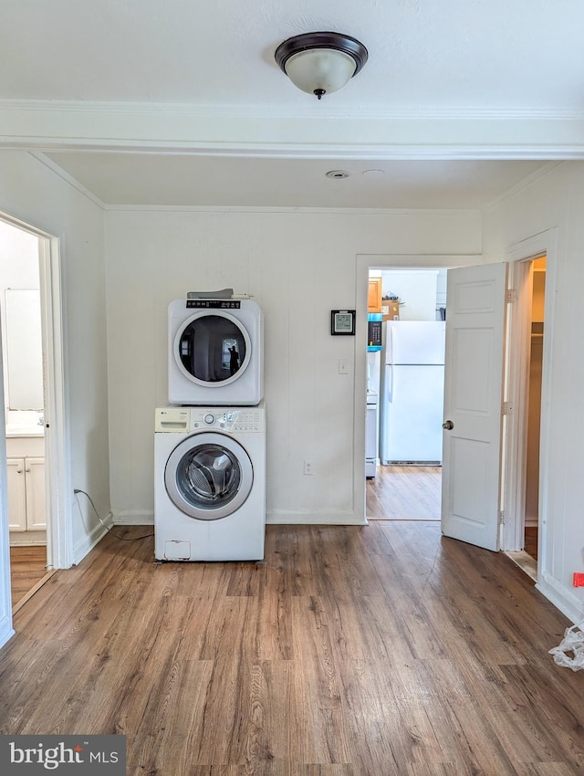 5200 Ballman, Brooklyn, MD 21225 - laundry area with wood finished floors, stacked washer and clothes dryer, laundry area, and baseboards