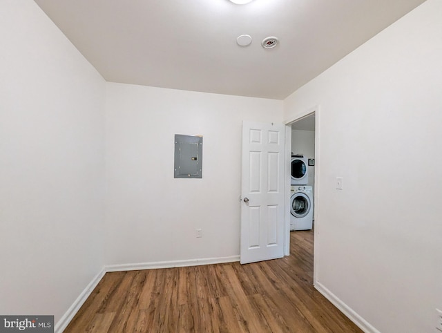 5200 Ballman, Brooklyn, MD 21225 - empty room featuring stacked washer / drying machine, electric panel, wood finished floors, and baseboards