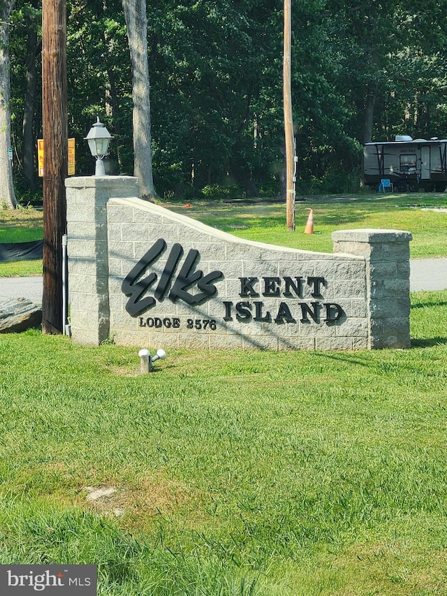 community / neighborhood sign with a lawn