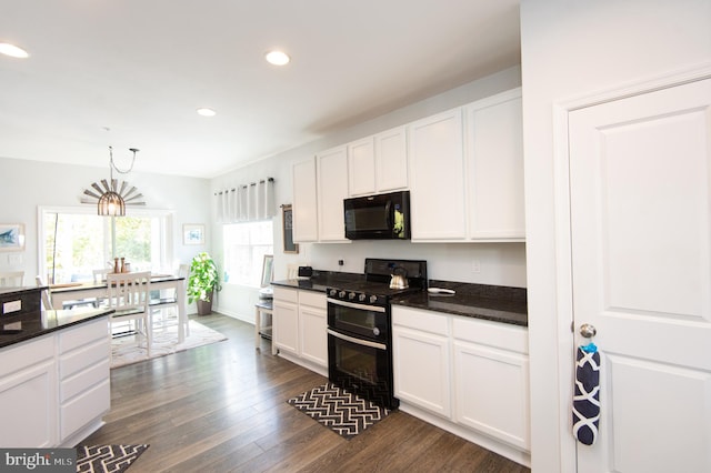 kitchen with black appliances, white cabinetry, decorative light fixtures, dark hardwood / wood-style flooring, and dark stone countertops