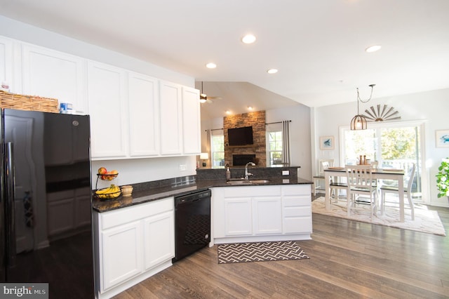 kitchen with dark hardwood / wood-style flooring, lofted ceiling, white cabinets, black appliances, and decorative light fixtures