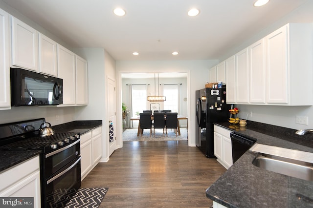 kitchen featuring black appliances and white cabinets