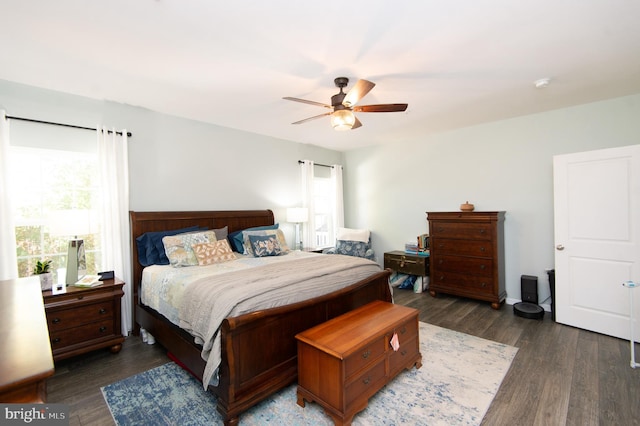 bedroom with dark hardwood / wood-style flooring and ceiling fan