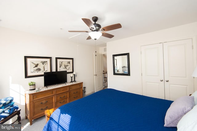 carpeted bedroom featuring ceiling fan and a closet