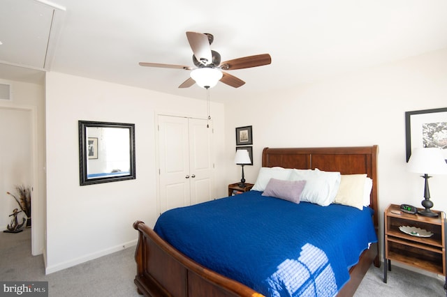 carpeted bedroom with ceiling fan and a closet