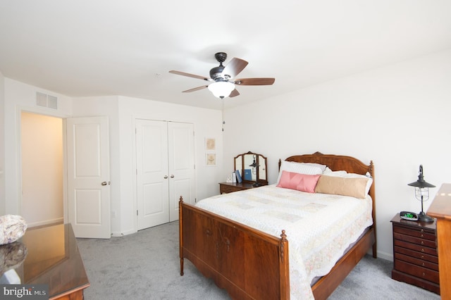 carpeted bedroom featuring ceiling fan and a closet