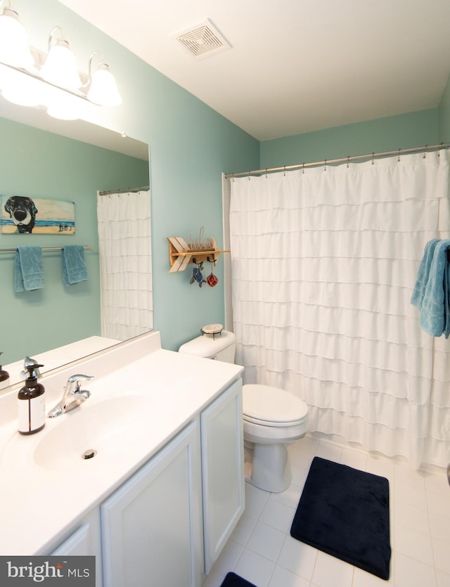 bathroom with toilet, vanity, tile patterned floors, and a shower with shower curtain