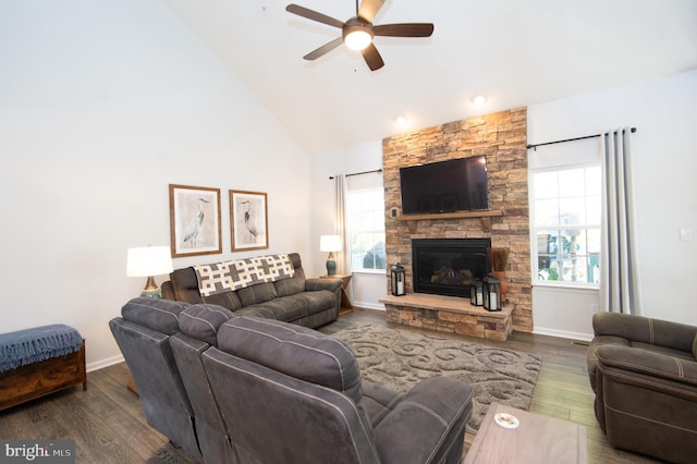 living room with dark wood-type flooring, high vaulted ceiling, ceiling fan, and a fireplace