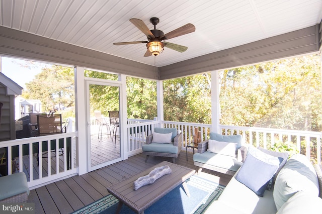 deck featuring ceiling fan and an outdoor hangout area