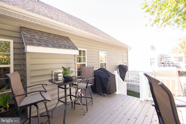 wooden deck with a grill