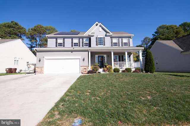 view of front of house with a garage, a front yard, and a porch