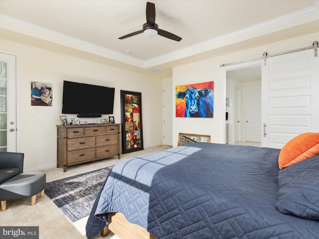 carpeted bedroom featuring crown molding, a barn door, and ceiling fan