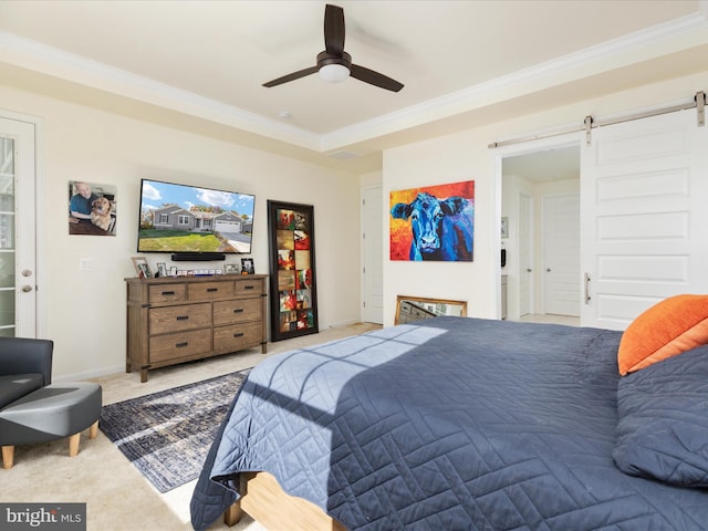 carpeted bedroom with ornamental molding, a barn door, and ceiling fan