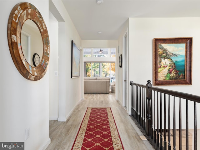 hallway with light hardwood / wood-style floors