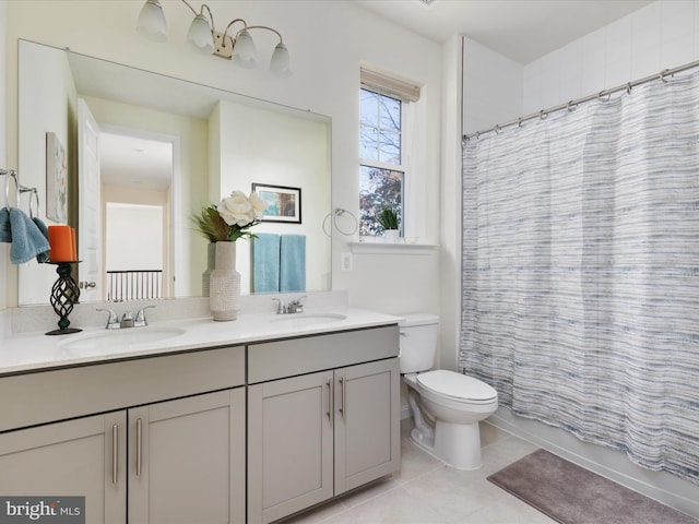 full bathroom featuring toilet, vanity, tile patterned floors, and shower / tub combo