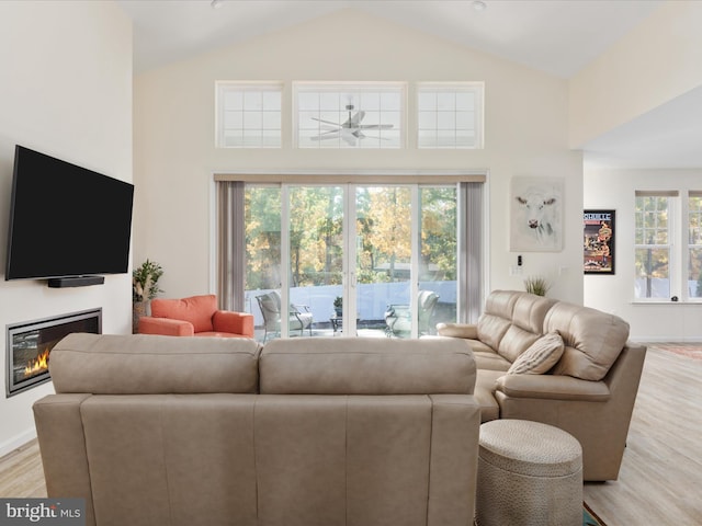 living room featuring a wealth of natural light, high vaulted ceiling, light hardwood / wood-style floors, and ceiling fan