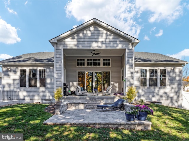 back of house with ceiling fan, a lawn, and a patio area