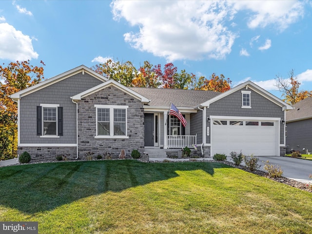 view of front of property featuring a front yard and a garage