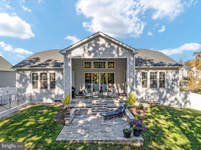 rear view of property featuring a yard and a patio area