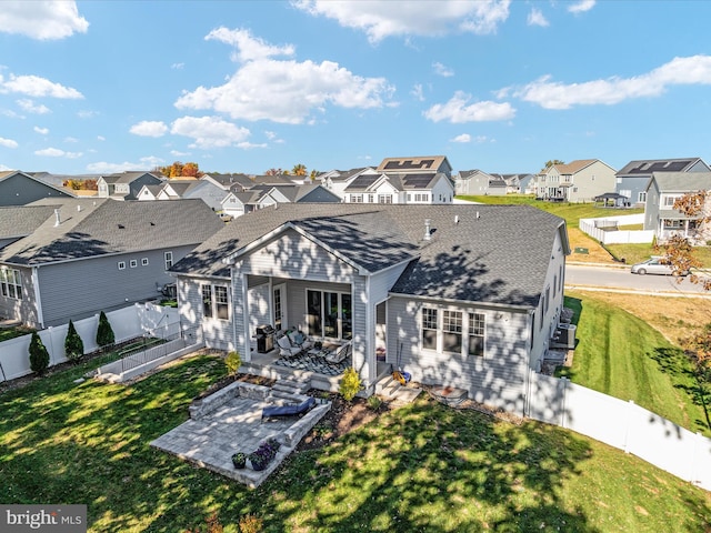 back of property with a patio area and a lawn