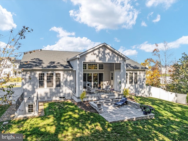 rear view of house with a patio and a lawn