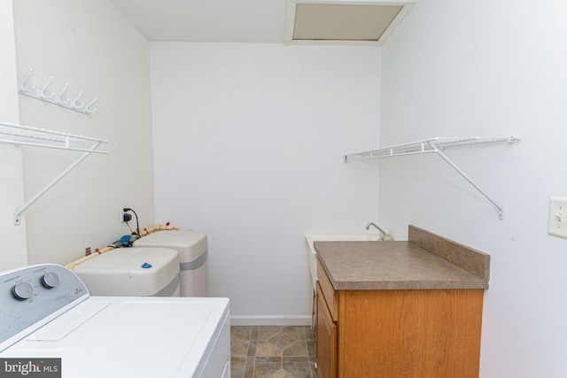 laundry area featuring washer / clothes dryer and cabinets