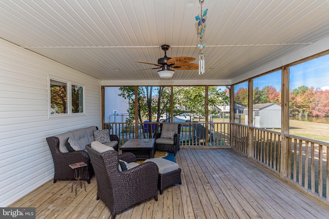 deck featuring outdoor lounge area, a storage unit, and ceiling fan