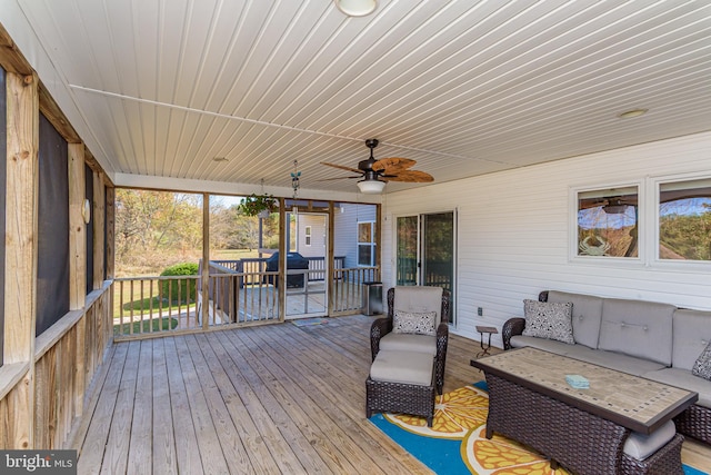 wooden deck with outdoor lounge area and ceiling fan