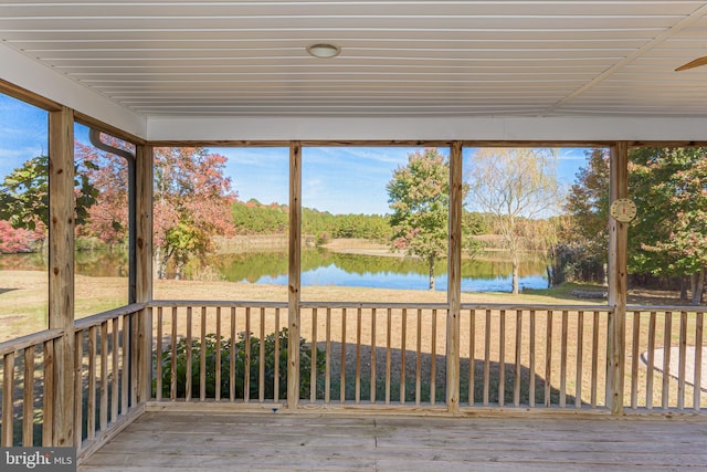 unfurnished sunroom with plenty of natural light and a water view