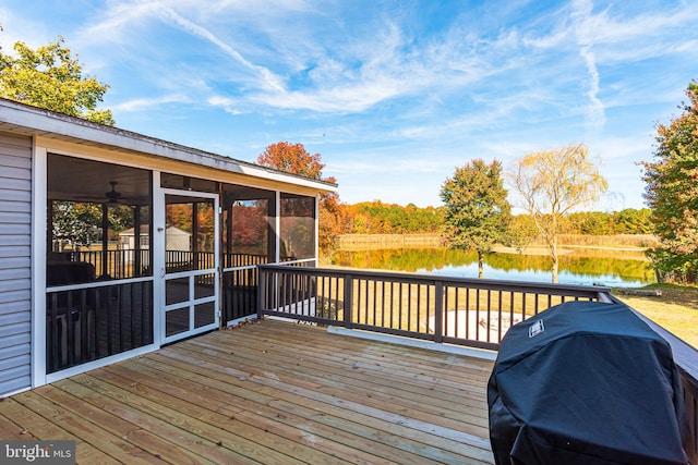 wooden terrace featuring a water view, a sunroom, and area for grilling