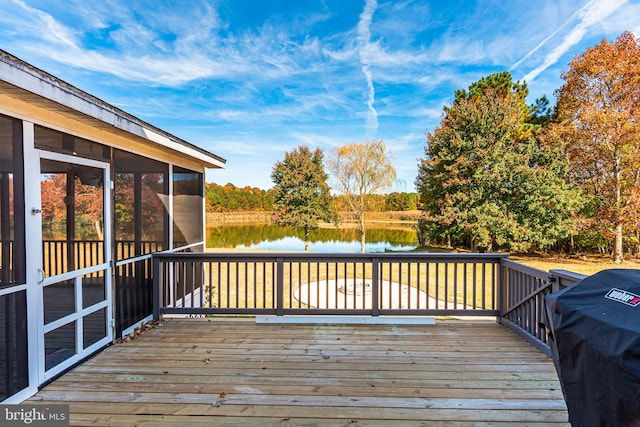 wooden deck with a sunroom, a water view, and a grill